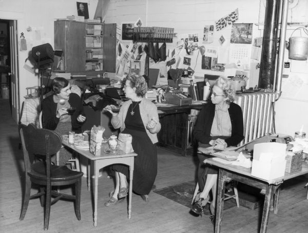 Dorothy Phelps and Ruth Bennett Dyer have lunch in the office at the Bennett Studio as Miriam Bennett looks on.