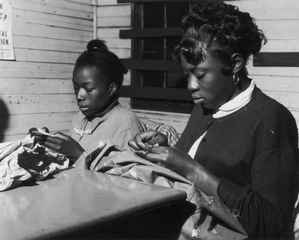 Two girls at Citizenship School learn to sew at Johns Island.