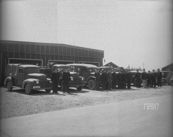 Truax Army Air Field Fire Station #1, with fire fighters and their trucks.