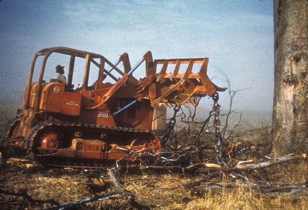 Color photograph of an International TD-20 crawler tractor (TracTracTor) with attached Drott shovel loader.