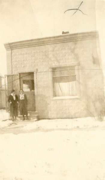 Two nurses stand outside the Colby Health Center, a former dental office. This was the first county health center, in a village of 700 population.