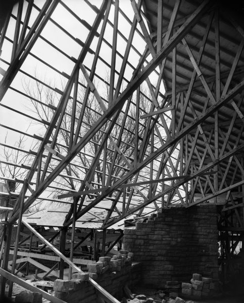 Roof trusses in auditorium of the First Unitarian Society Meeting House during construction. The building was designed by Frank Lloyd Wright.