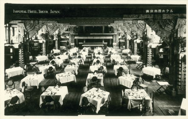 Interior of the Imperial Hotel dining room, Tokyo, Japan, designed by architect Frank Lloyd Wright, showing the tables set for dinner guests.