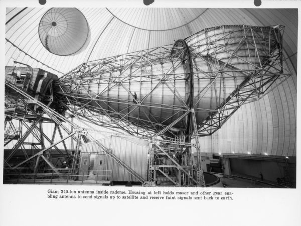 Giant 340 ton antenna inside radome. The housing at the left holds maser and other gear-enabling antenna to send signals up to the satellite and receive faint signals sent back to earth.