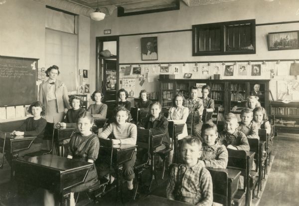 Reed School teacher, Mrs. Orvilla Zillic, and her 17 students pose for a photograph. Built in 1915, the school became the Wisconsin Historical Society's 10th historic site in 2007. This image is the interior of Reed School in the late 1940's.