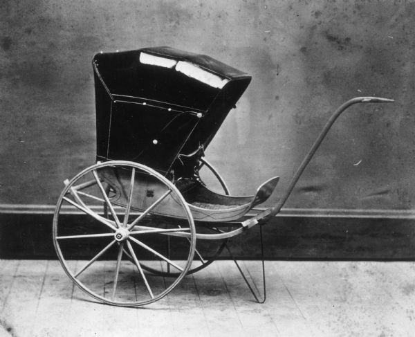 Two wheeled rear facing carriage produced at children's carriage factory.