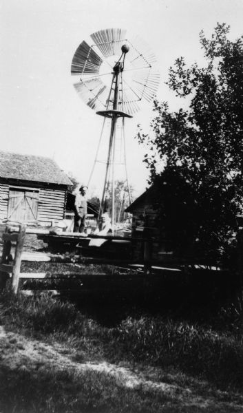 Maria and Henry Getto in the yard of their farm with windmill in the background, Oulu Township.