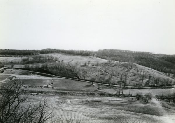 From back of print: "Dane County, Town of Middleton, north 1/2 section of section 17 looking SW from a hill across the valley showing erosion and stump pasture. Practically all land abuses may be seen in this one photo from cultivating and pasturing of slopes to denuding of the hillsides; also drainage ditch across foreground and the running of corn rows straight down hill. Value of this land now practically nil."