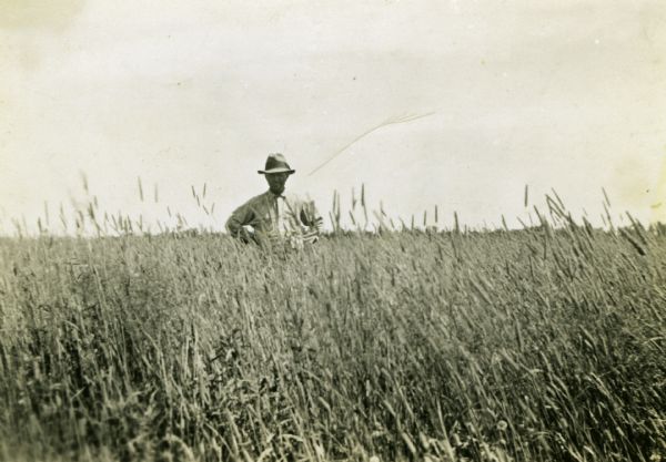 John S. Bordner standing in a hay field.