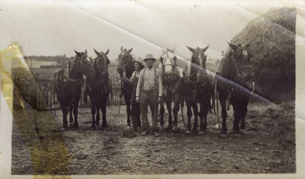 John Bordner and another man standing with a team of six horses.