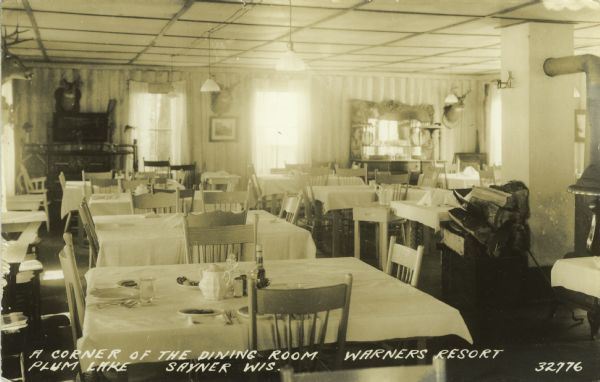 View of the dining room at the resort. Caption reads: "A Corner of the Dining Room, Warner's Resort, Plum Lake, Sayner, Wis."