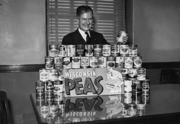 Governor Phil La Follette with a display promoting Wisconsin peas.