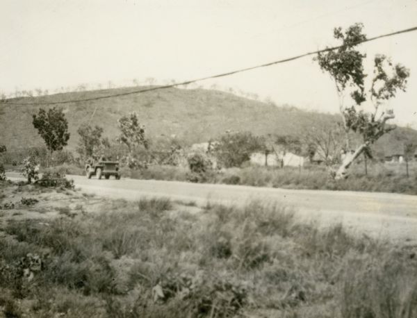 Correspondents' hut from across the main road, Port Moresby, New Guinea.  Photograph taken between October and December, 1942.