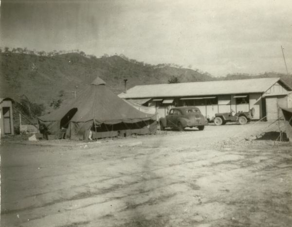 Rear view of the correspondents' hut, with the tent used by the staff of the Australian soldiers in Port Moresby, New Guinea. This photograph was taken between October and December in 1942.