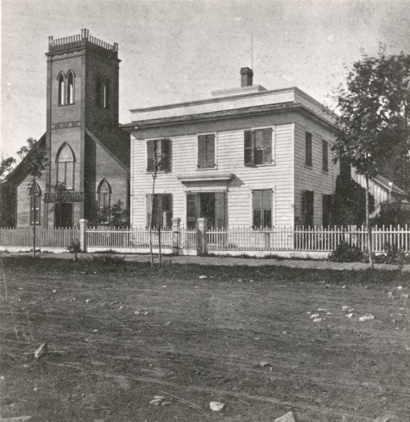 Congregational Church, also called the "old brown church" built in 1853 and burned in 1893. It was on the site of the present City Hall. The white house next door on the right is unidentified.