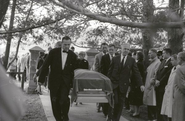 A group of pallbearers carry the casket containing Frank Lloyd Wright's body to its final resting place in the Unity Chapel Cemetery.