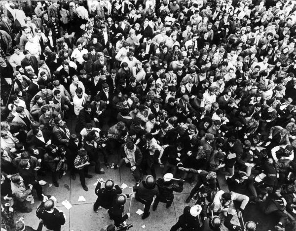 Overhead view of large crowd of demonstrators being beaten back by police at the University of Wisconsin-Madison during the Dow Chemical demonstration on campus.  