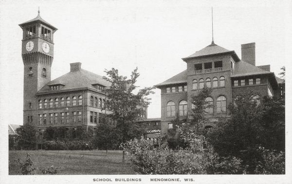 School buildings in Menomonie, later a part of the Stout State College. The building on the left has a clock tower. Caption reads: "School Buildings, Menomonie, Wis."