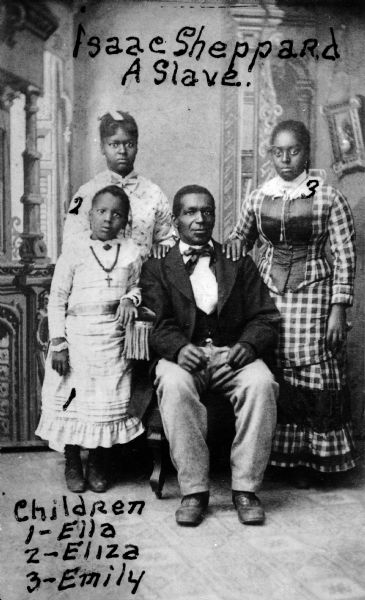 Formal studio portrait of Isaac Sheppard, a former slave, posing with his daughters Ella, Eliza, and Emily.