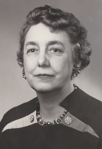 Studio portrait of Aline W. Hazard wearing earrings and a necklace.