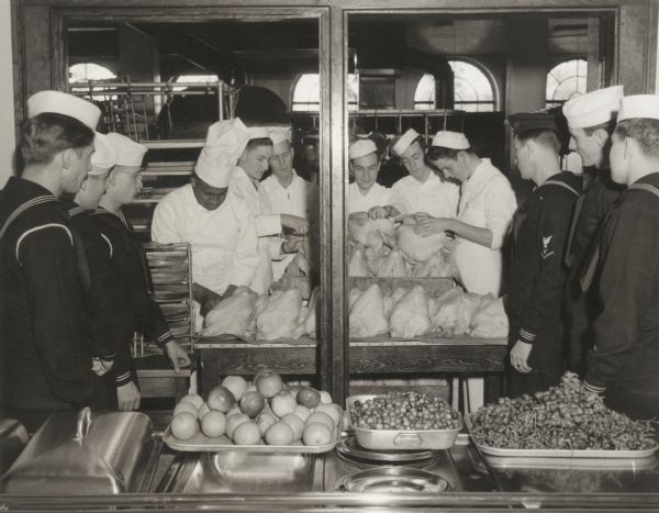 Navy cooks and bakers assisting a demonstration by Chef Carson Gulley, UW residence hall chef.