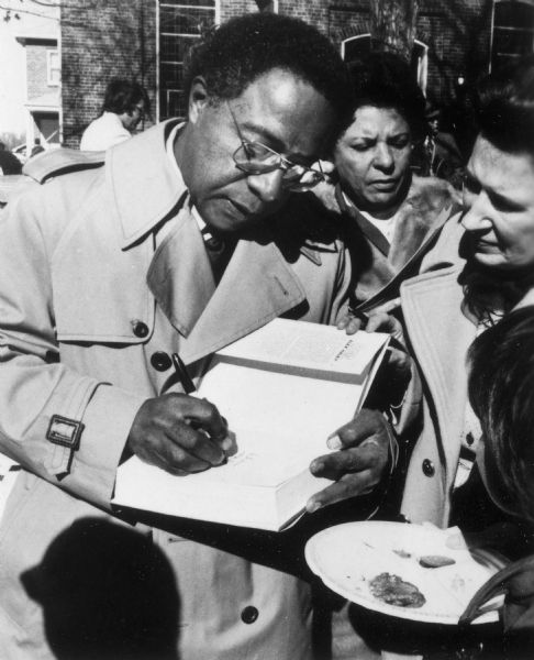 Author Alex Haley autographing a copy of his best selling book, <i>Roots</i>, during a visit to Spottsylvania County, Virginia, where his ancestor Kunte Kinte lived and died.