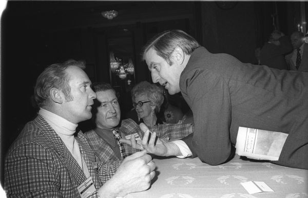 Senator Walter Mondale of Minnesota was a featured speaker at an agricultural conference in Milwaukee.  Here he leans across the head table to speak with some Wisconsin voters.  Mondale was then considering a presidential campaign. Instead, in 1976 he was elected vice-president on the Carter-Mondale ticket.