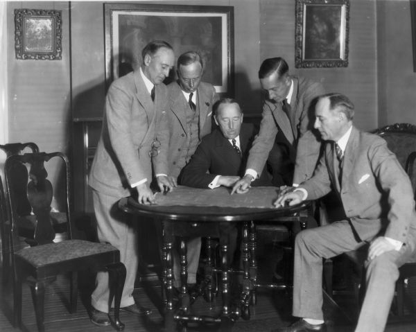 Members of the Jackson family review building plans for the Jackson Clinic. They are identified left to right: James Jackson, Jr., Joseph W. Jackson, Sr., Arnold Jackson, Reginald Jackson, and Reginald Jackson.