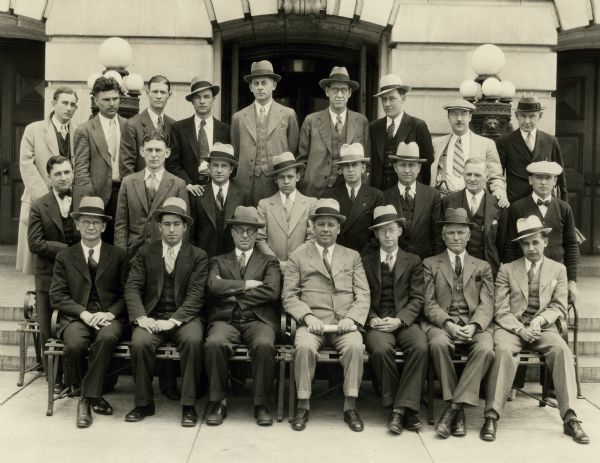 Portrait outside the Wisconsin State Capitol of the Chief Clerk's Force, Wisconsin Assembly. In the front row from left to right are Femrite, West, Pinkerton, C.E. Shaffer, Hackney, Tuffley, and Dexter Munson. In the middle row from left to right are Peterson, Whitman, Rivers, Haugen, Ballam, Walden, Ellis, and Degner. In the back row from left to right are Miller, Schubert, Stadelman, Huddleston, Gilbertson, Dean, Engebretson, Middleton, and Watson.