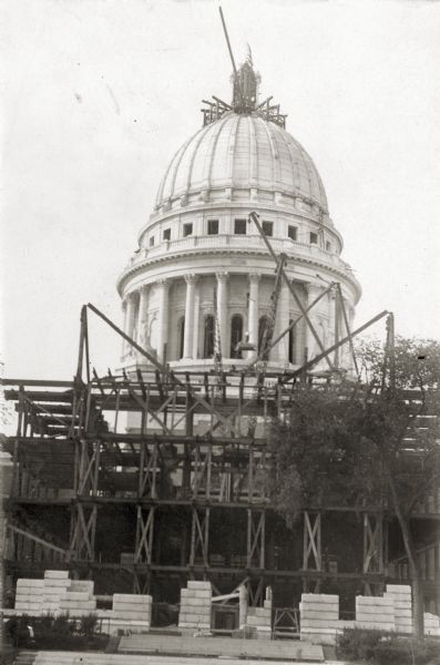 North wing of the Wisconsin State Capitol under construction, with construction scaffolding in the foreground.