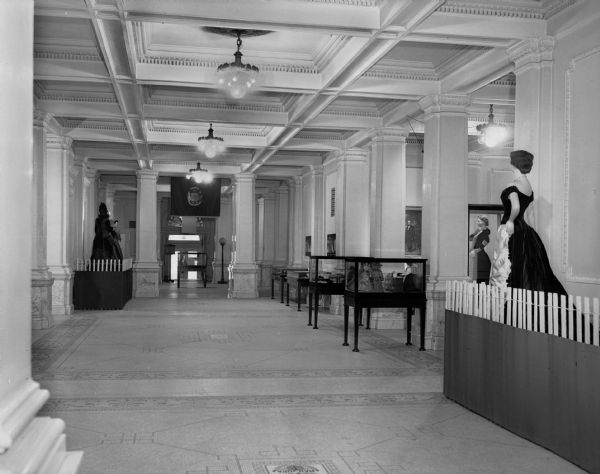 Costume collection exhibit in the first floor lobby of the State Historical Society building.  View is of the west wall looking toward the south entrance.