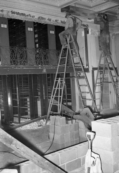 Construction work on the mezzanine shelving in the old Library Periodical Room.  The old shelving was reconfigured, beams installed, and an small office created to house the Wisconsin Historical Society's McCormick Collection and staff.