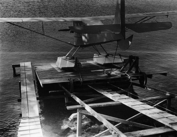 Rear view of Aeronca airplane entering the water at the end of the Marine Railway.