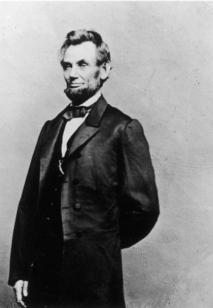 Three-quarter length portrait of Abraham Lincoln standing.