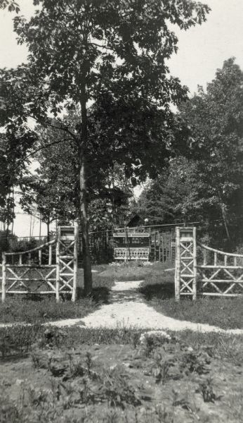 The entrance to the garden framed by a decorative wooden gate.