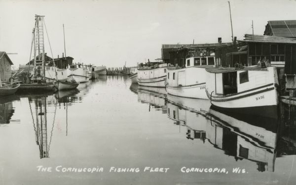 Fishing Fleet in the harbor. Caption reads: "The Cornucopia Fishing Fleet, Cornucopia, Wis."