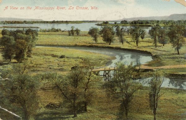 Elevated view of winding tributaries leading to Mississippi River. A road passes over a bridge in the foreground. Caption reads: "A View on the Mississippi River, La Crosse, Wis."