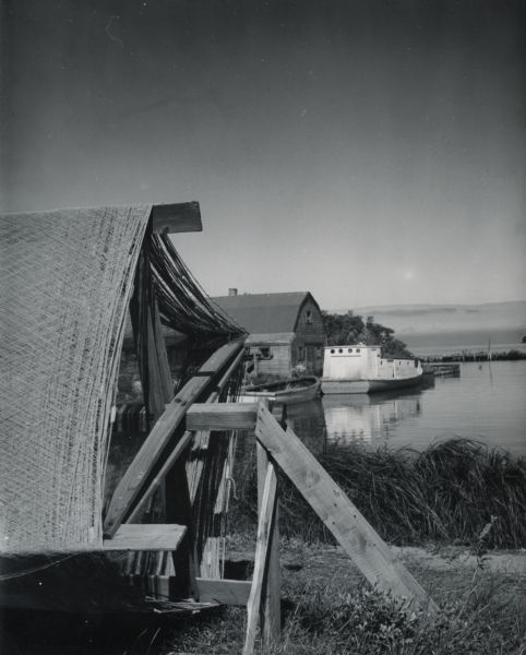 Fishing net and boat dock on shoreline.