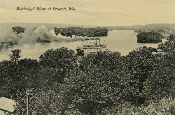 Elevated view over trees toward a steamboat on the Mississippi River. Caption reads: "Mississippi River at Prescott, Wis."