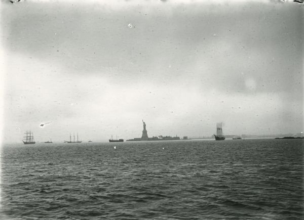 New York Harbor, with the Statue of Liberty and various boats.
