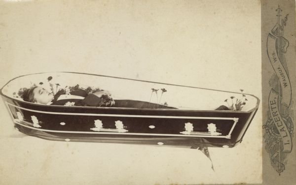 Deceased body of a man in coffin.