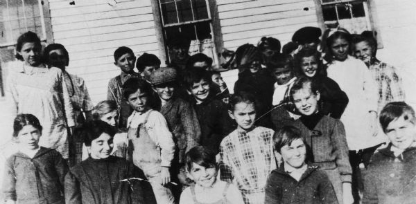 Class group portrait of Joseph R. McCarthy's grade school classmates. McCarthy is in the center of the group. McCarthy dropped out of school at age 14.