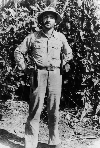 Candid portrait of Joe McCarthy wearing a pith helmet during World War II.