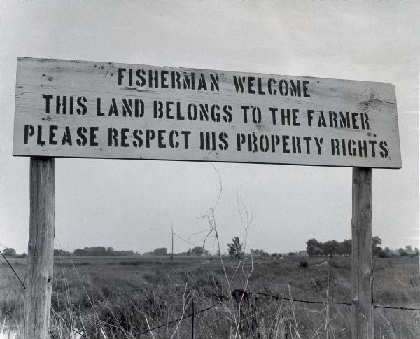 Sign posted on a southern Wisconsin trout stream. The photographer would not divulge the stream on which the sign was placed lest it be overrun by enthusiastic anglers, and the farmer, forced to take down the sign and substitute the "No Trespass" sign.