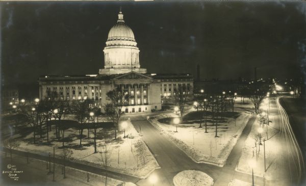 Elevated view at night of the Wisconsin State Capitol, including Carroll Street and Main Street.