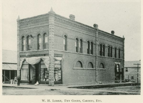 Exterior view of W.H. Lemke's store, which features dry goods, carpet, and more.