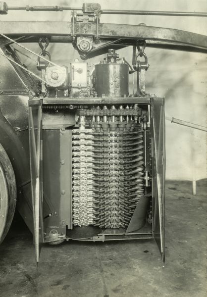 Engineering photograph of the right side of a short tapered spindle cotton picker with the drum exposed.
