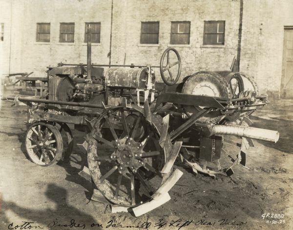 Engineering photograph of an experimental pneumatic spindle cotton picker on a Farmall tractor.