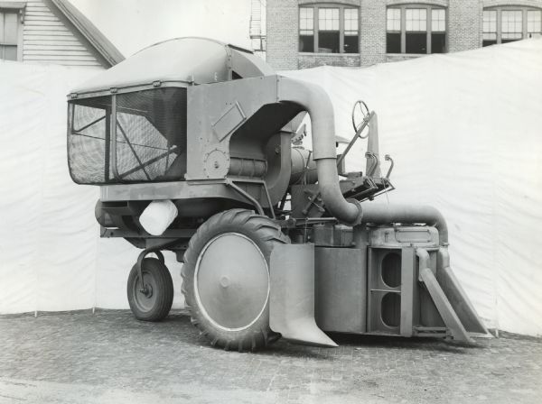 Engineering photograph of an experimental cotton picker for the 1944 season mounted on a Farmall "H" tractor.