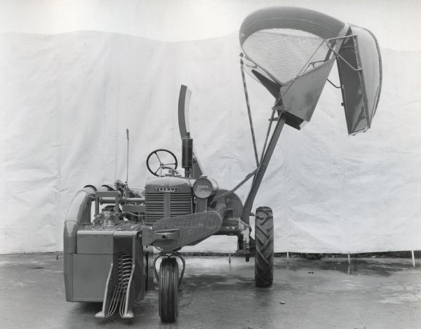 Engineering photograph of an experimental cotton harvester [picker] mounted on a Farmall "B" tractor.